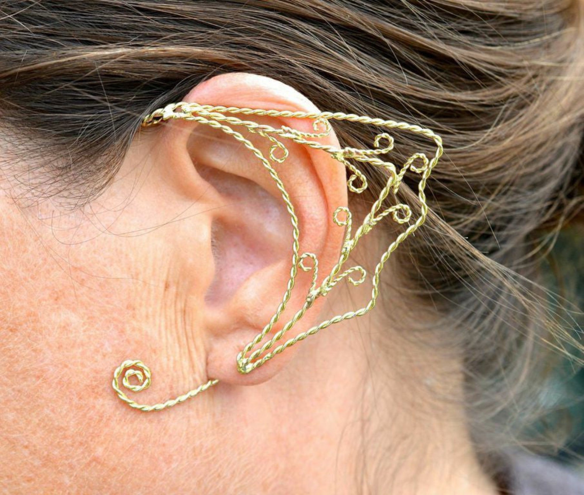 Gold small spiral wire elf ear cuff worn on ear non piercing fantasy elven ear wrap jewelry side view