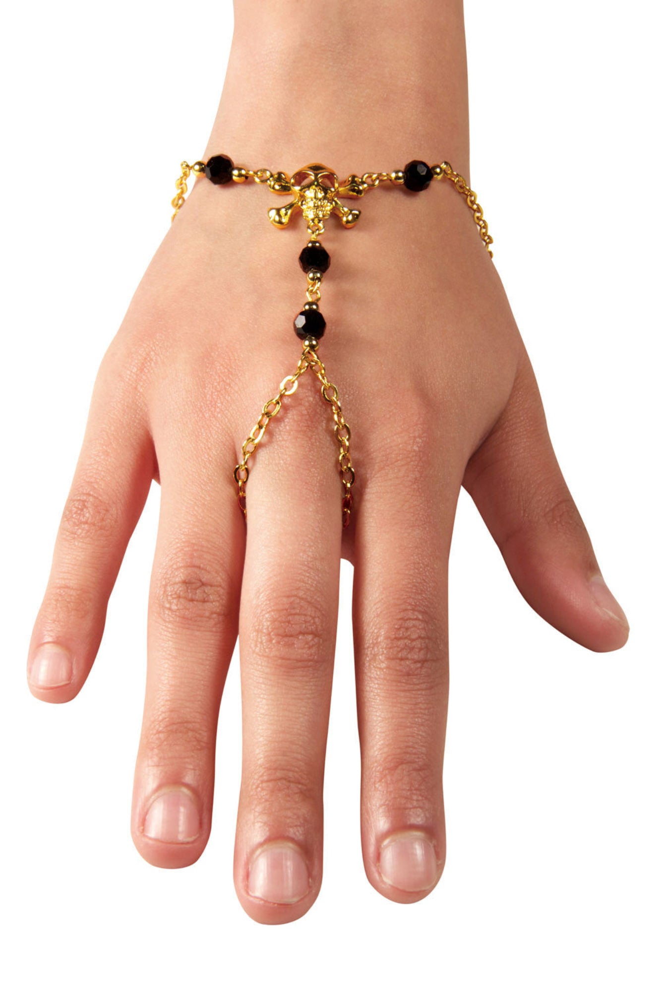 Gold skull and crossbones hand chain finger bracelet with black bead accents worn on hand