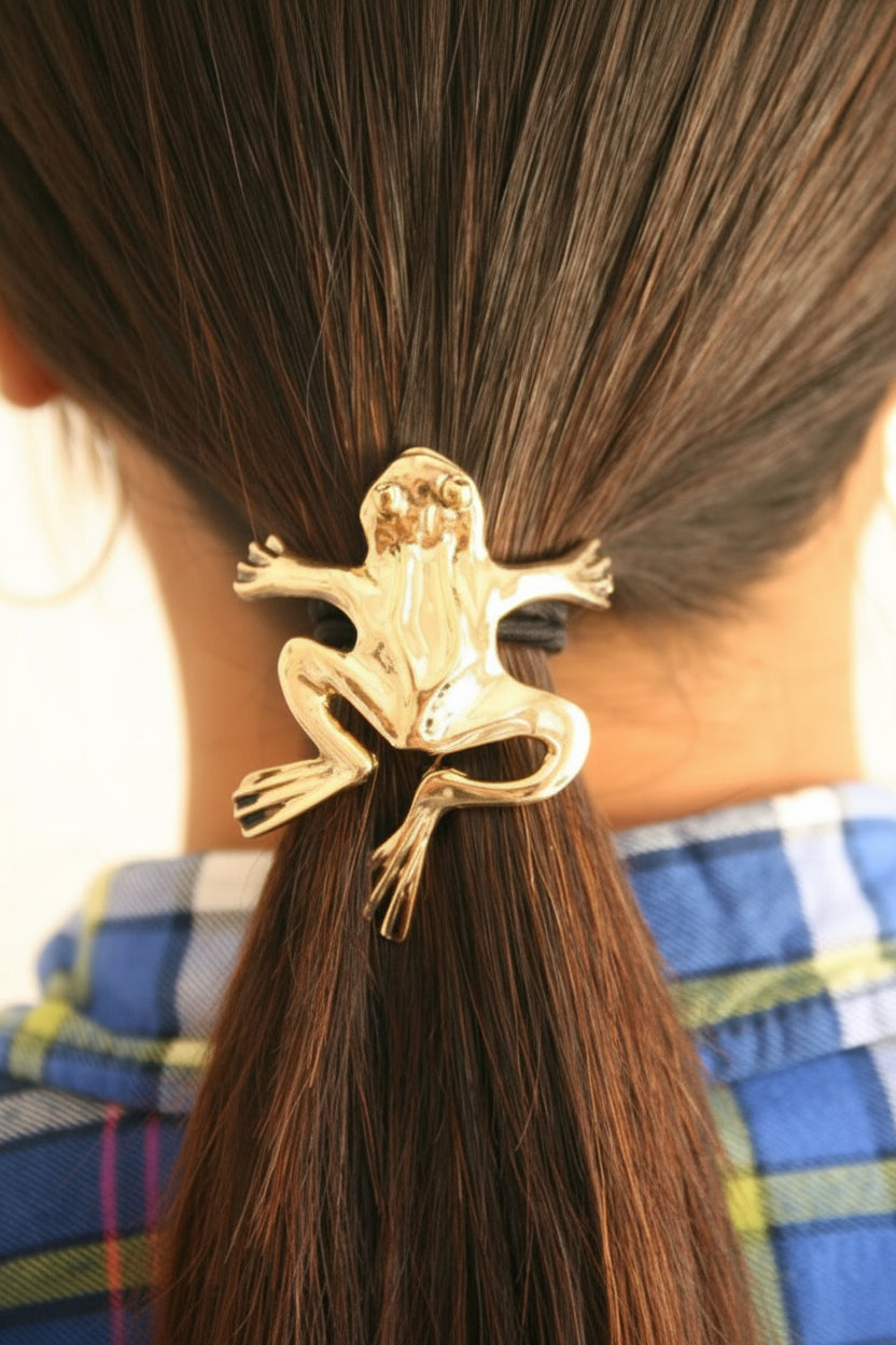 Gold frog ponytail hair hook securing ponytail, back view