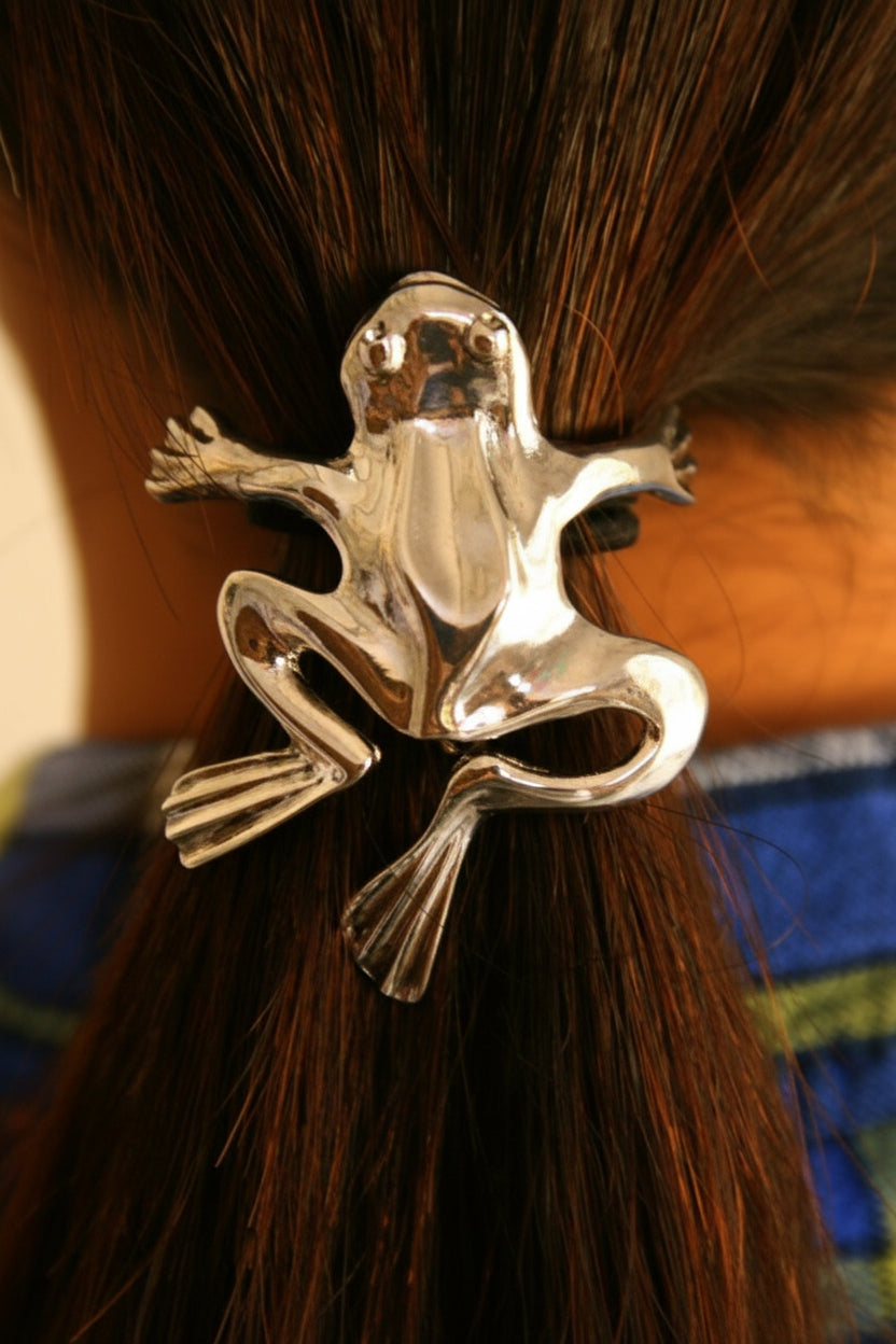 Silver frog ponytail hair hook securing ponytail, back view