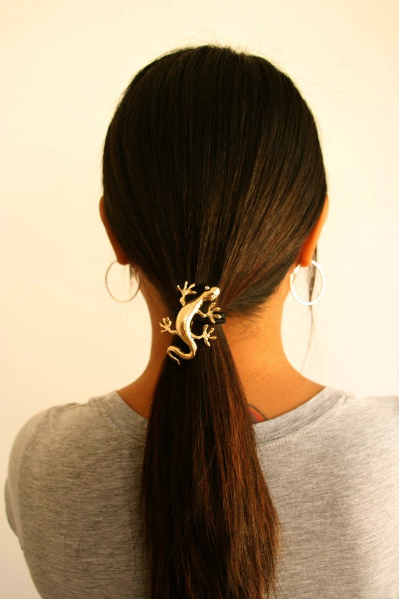 Gold gecko ponytail hair hook securing ponytail, back view