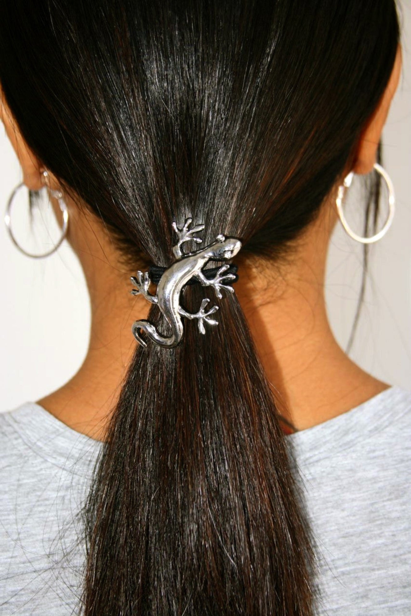 Silver gecko ponytail hair hook securing ponytail, back view