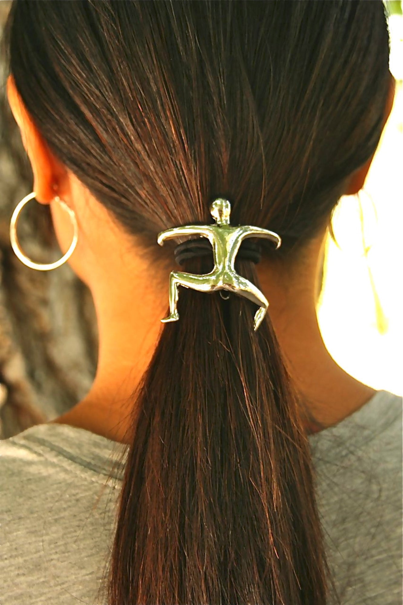 Model wearing silver Hang Man ponytail hair hook, back view