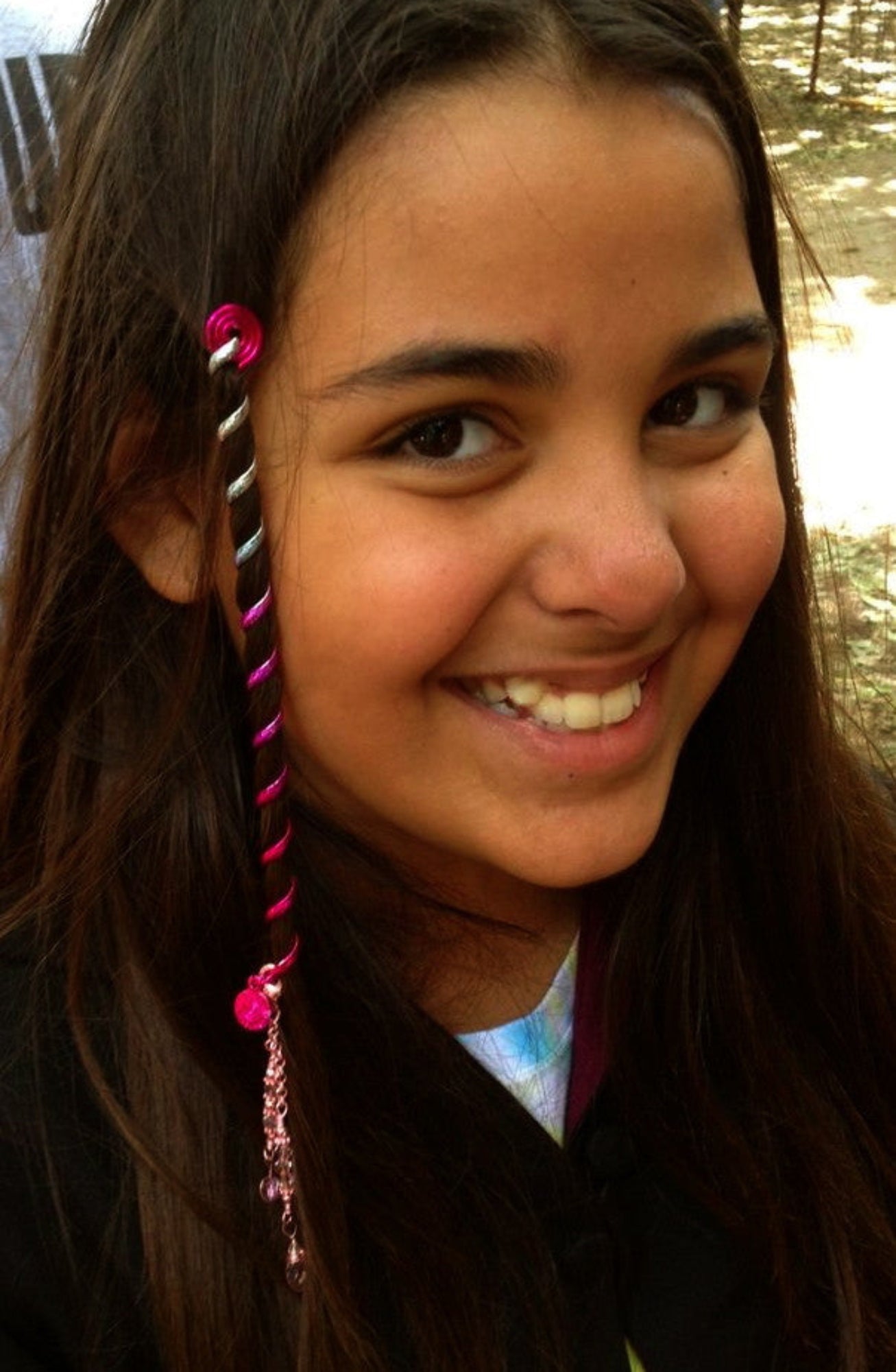 Model wearing 6 inch pink rainbow spiral hair twister, side view