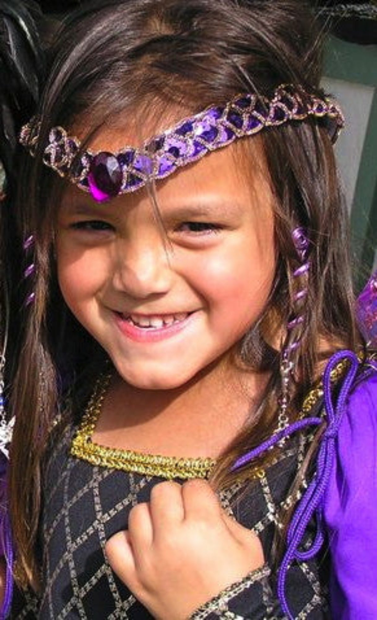 Young model wearing 2 inch purple rainbow spiral hair twister, lifestyle view