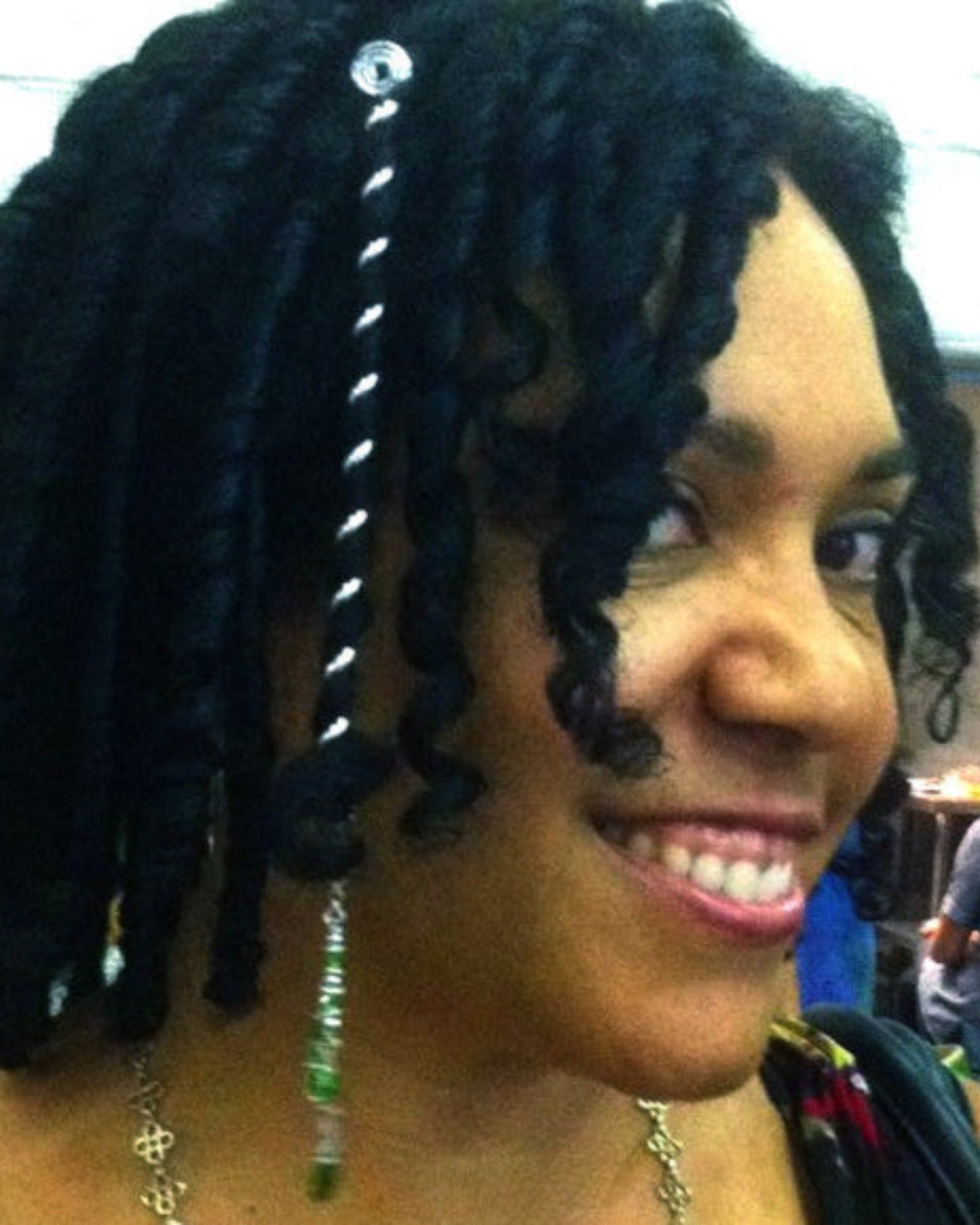 Model wearing silver 6 inch spiral hair wrap in curly textured hair, lifestyle view