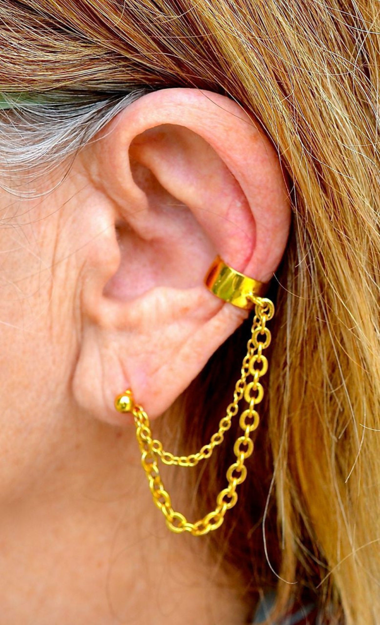 gold ear cuff with chain to stud earring worn on ear non piercing double chain side view