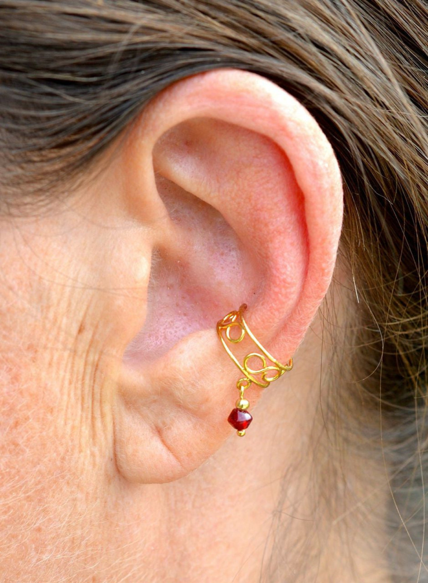 gold organic spiral ear cuff worn on ear non piercing earring side view