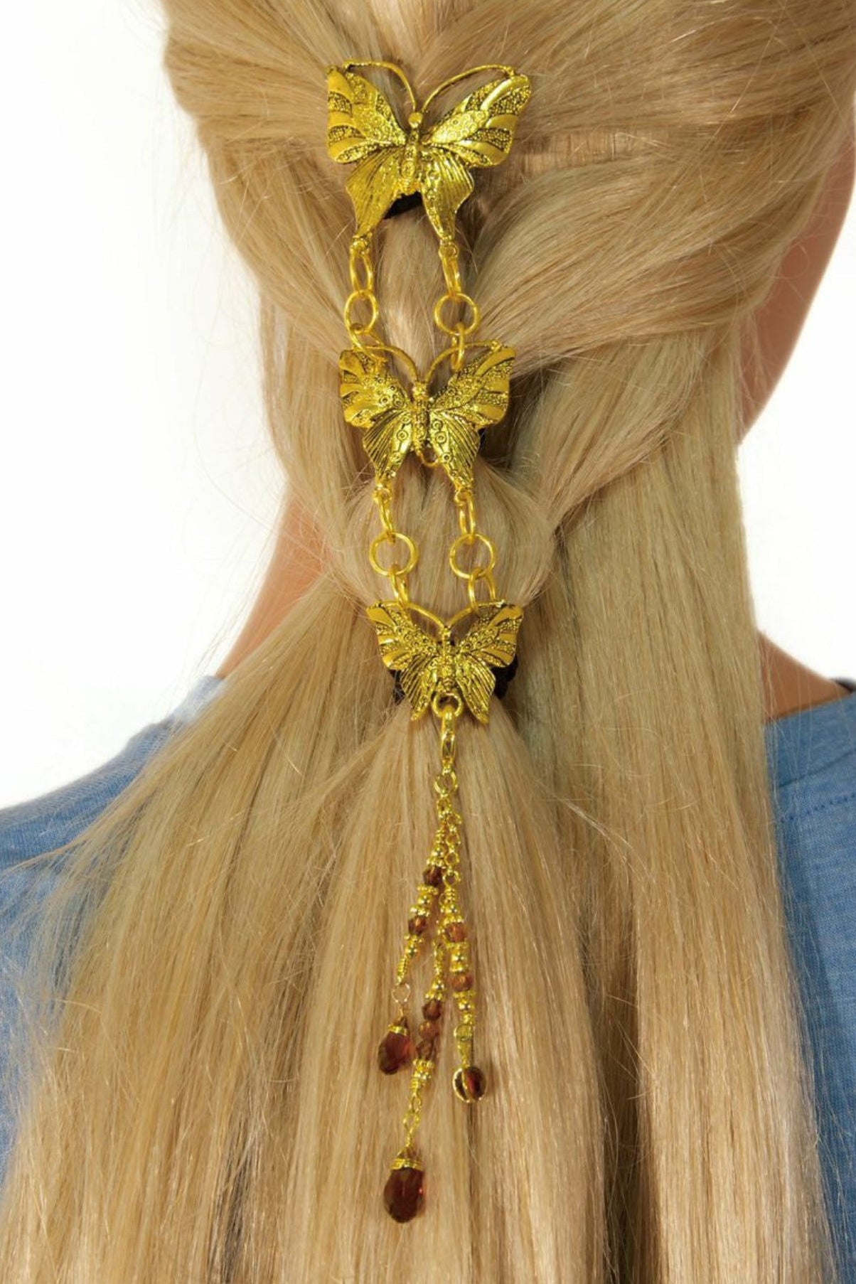 Gold butterfly hair hook with linked chain pendants worn in hair, back view