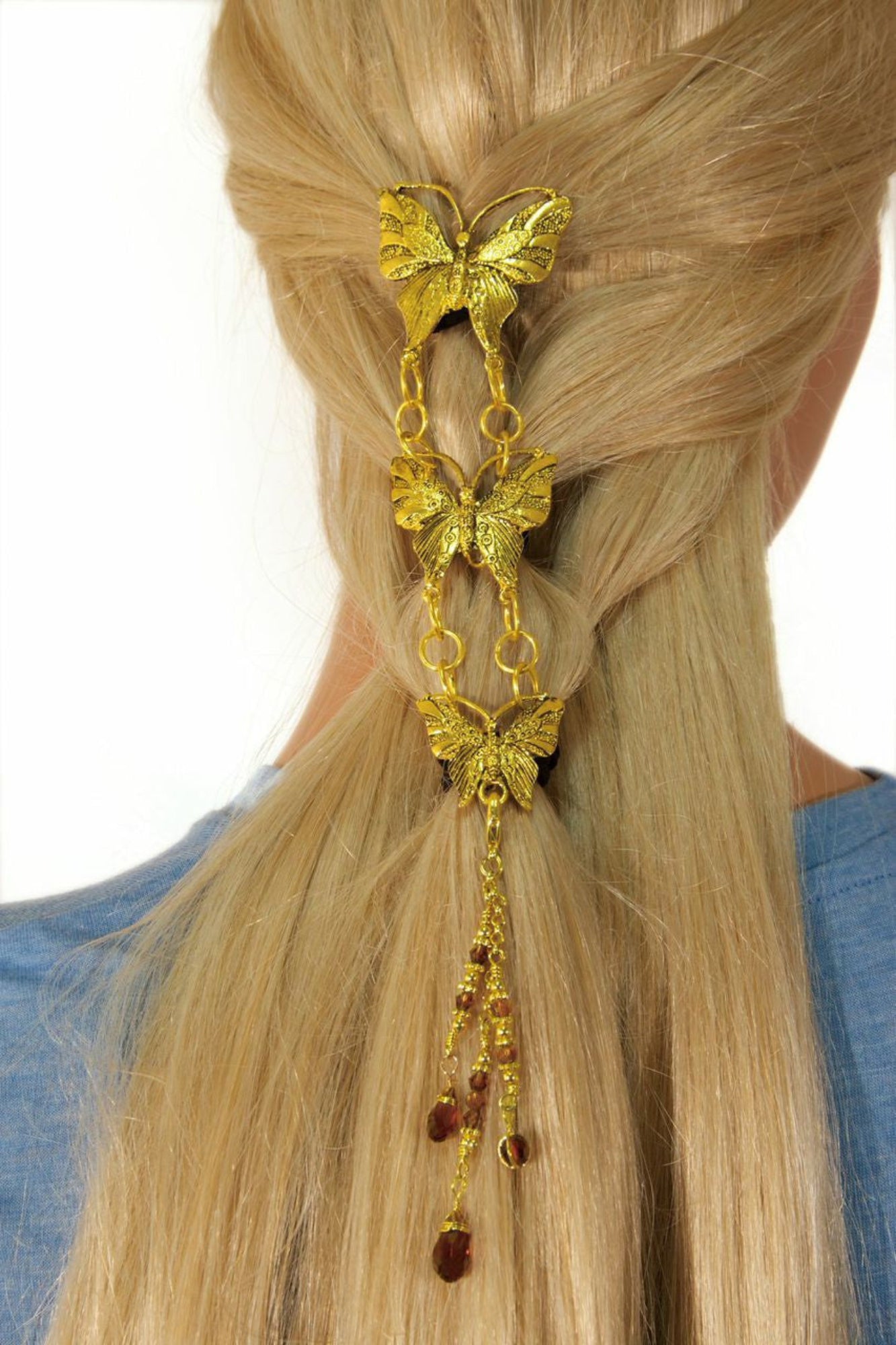 Gold butterfly hair hook with linked chain pendants worn in hair, back view