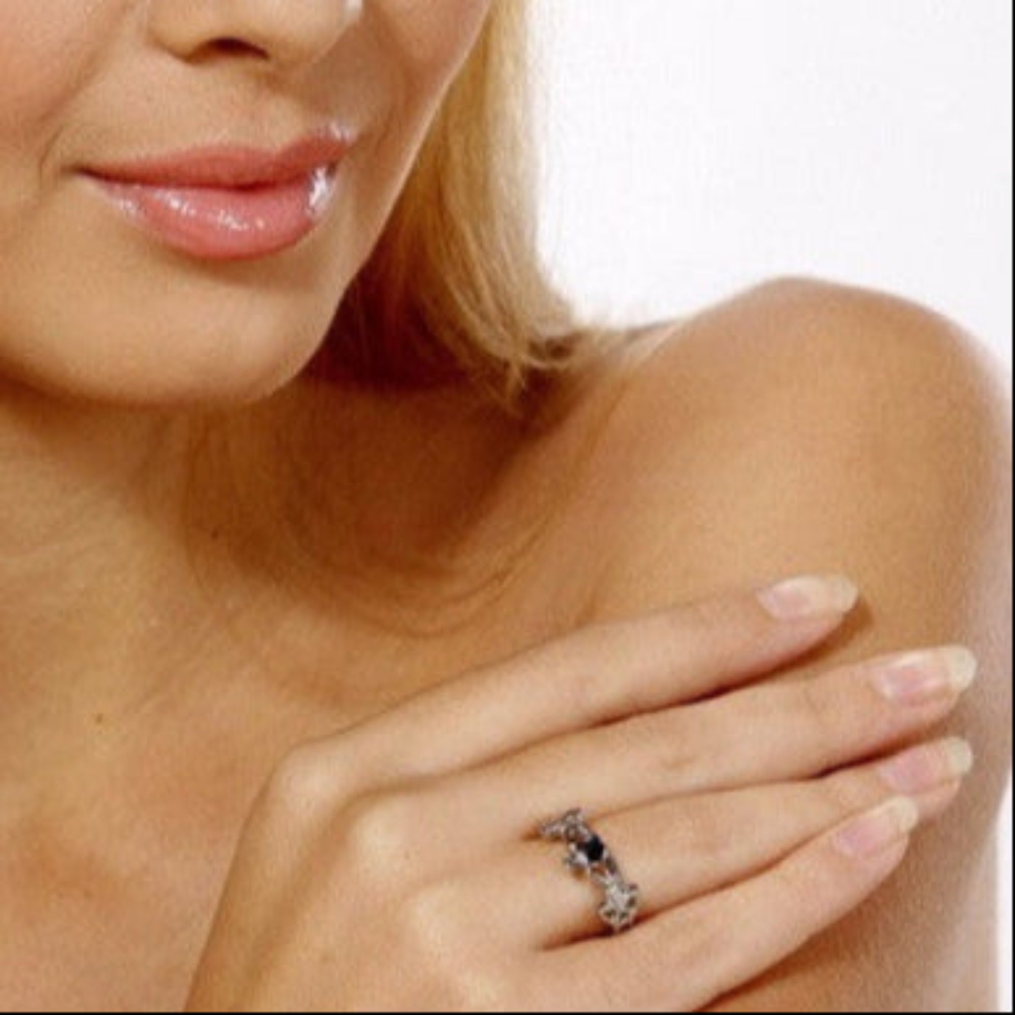 model wearing silver claddagh ring with celtic knot band on hand close up