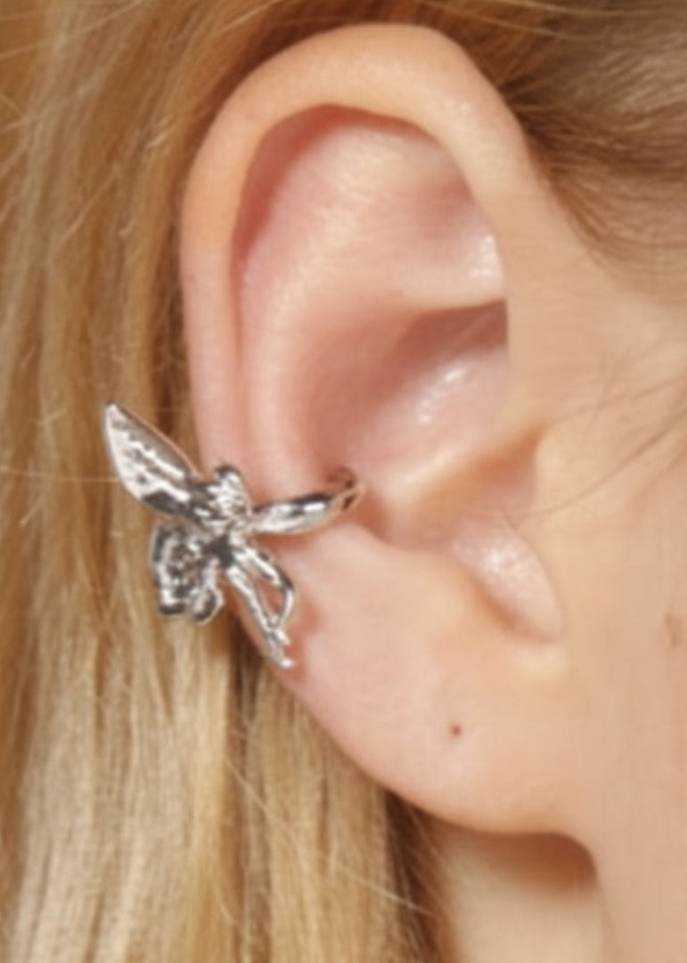 Model wearing silver fairy ear cuff non piercing fantasy jewelry with winged fairy design