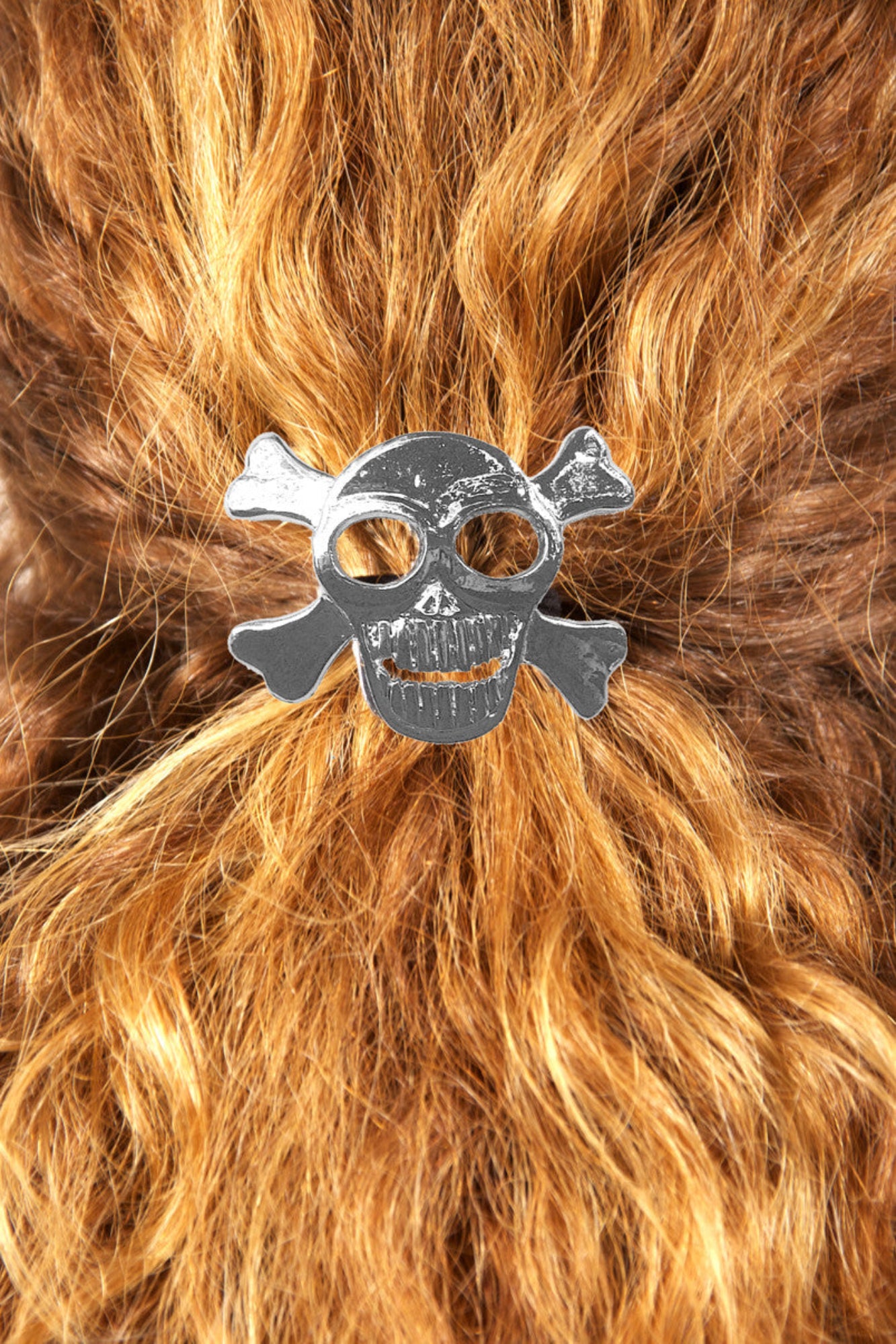 Silver skull and crossbones hair hook securing ponytail, back view
